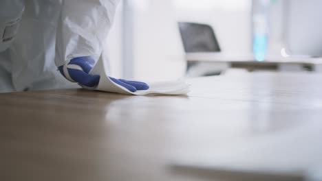 close up video of human hands cleaning desk with disinfectant wipe