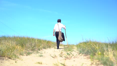 Actor-portraying-Hungarian-poet-Sandor-Petofi-walks-up-hill-on-dirt-path