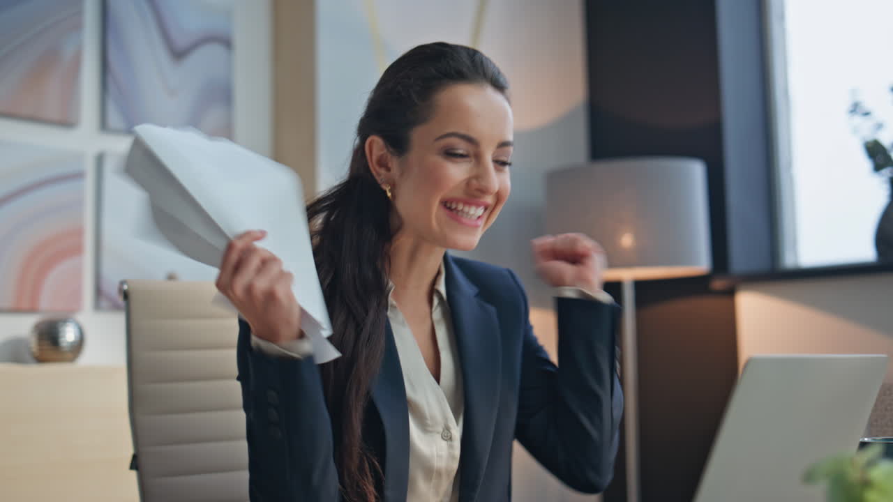 Satisfied employee reading report working computer at light workspace closeup