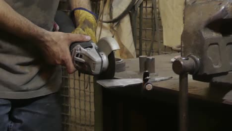 man works circular saw. flies of spark from hot metal. the man's hard work. man worked over the steel in workshop. close-up of hand and electric saws metal. close-up of hand tool.