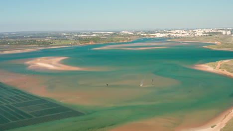 aerial: aquaculture and kitesurfing in the lagoon of alvor in portugal