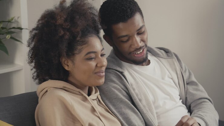Young Couple Having Fun While Watching A Movie On Tv 1