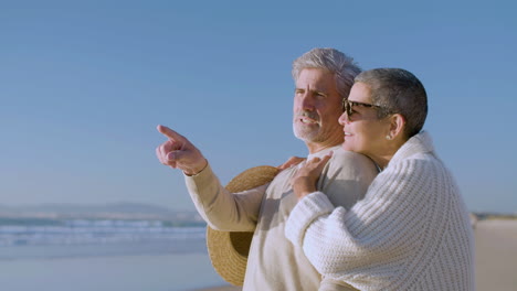 Una-Pareja-Romántica-De-Ancianos-Abrazándose-Mientras-Hablan-Y-Disfrutan-De-La-Vista-En-La-Playa