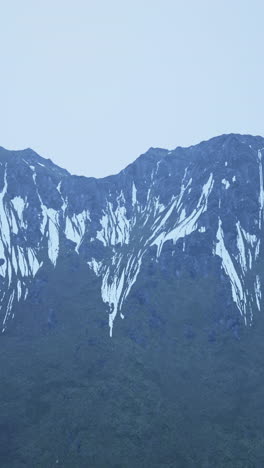 snow-capped mountains under a cloudy sky