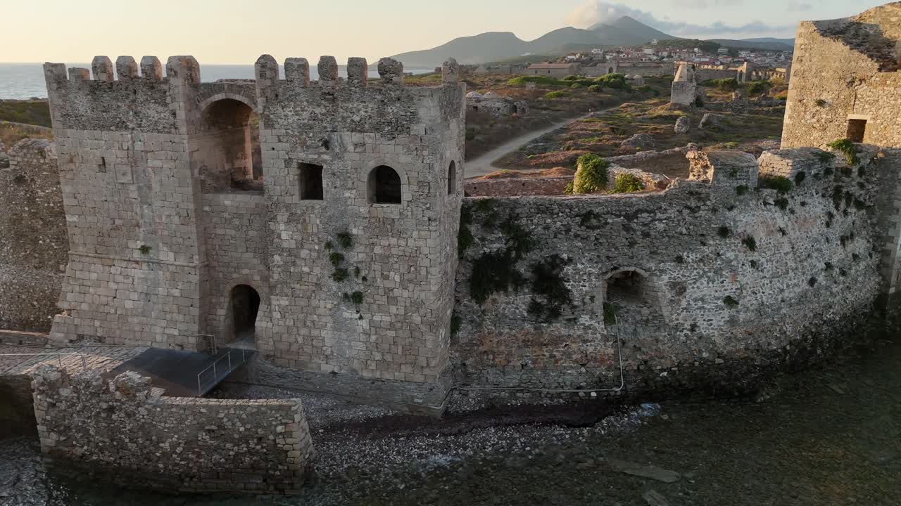 Methoni,Messenia,Peloponnese,Aerial view slight circle pan left around Methoni Castle Towers by the seaduring sunset