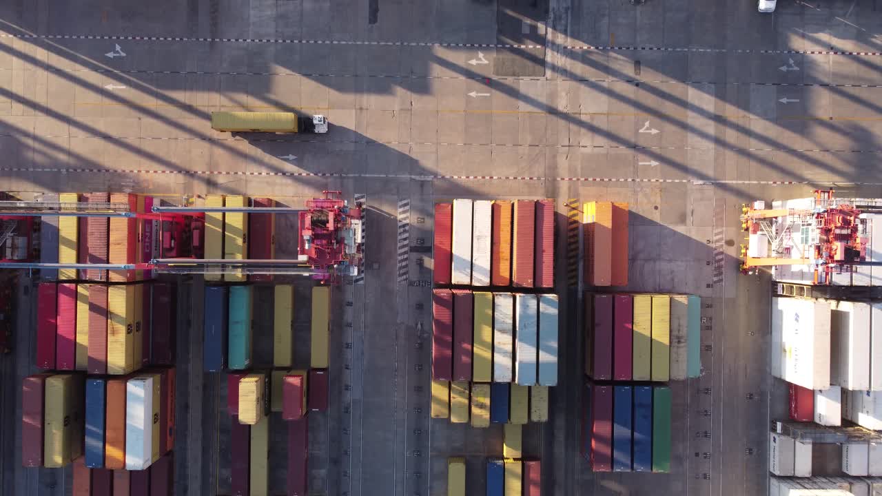 Aerial overhead shot of truck driving on container port of Buenos Aires during sunset time