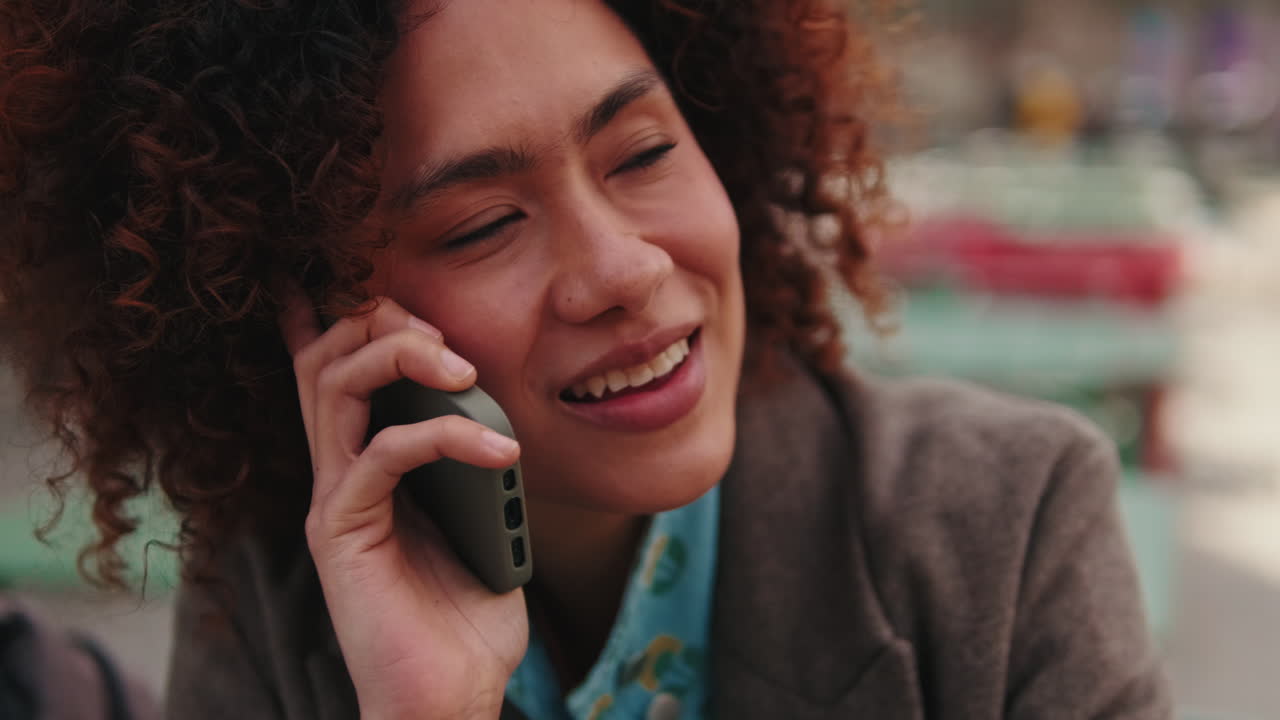 Woman Talking on Mobile Phone Outdoors