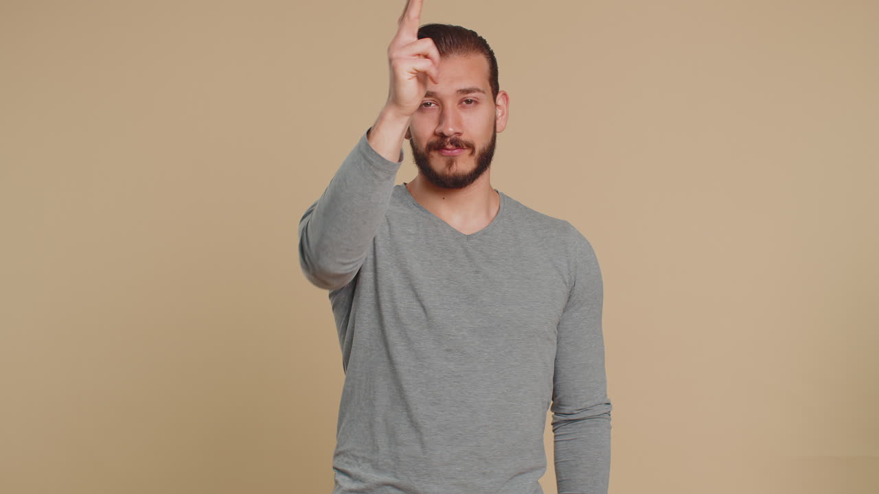 Man pointing around with finger gun gesture making choice shooting killing pistol right on target