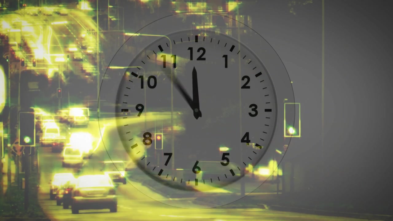 Rapidly Moving Clock Over Busy City Traffic at Night