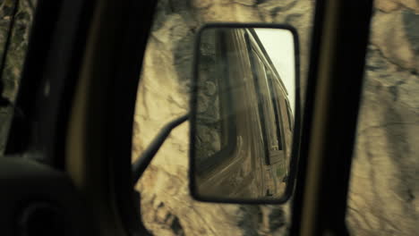 car mirror reflection on a drive