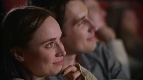 young couple enjoying romantic film in the cinema