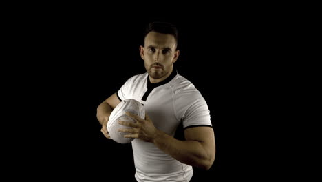 Serious-rugby-player-holds-rugby-ball