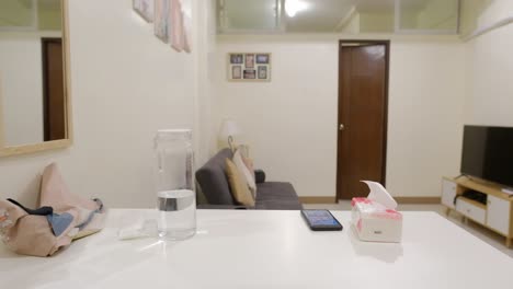 young asian female student clearing plate from table after finished eating