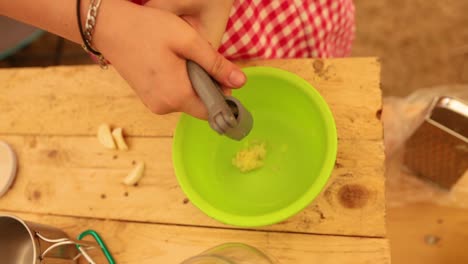 Women-Hands-Squeeze-The-Garlic-Into-Bowl-With-Garlic-Press,-Close-Up