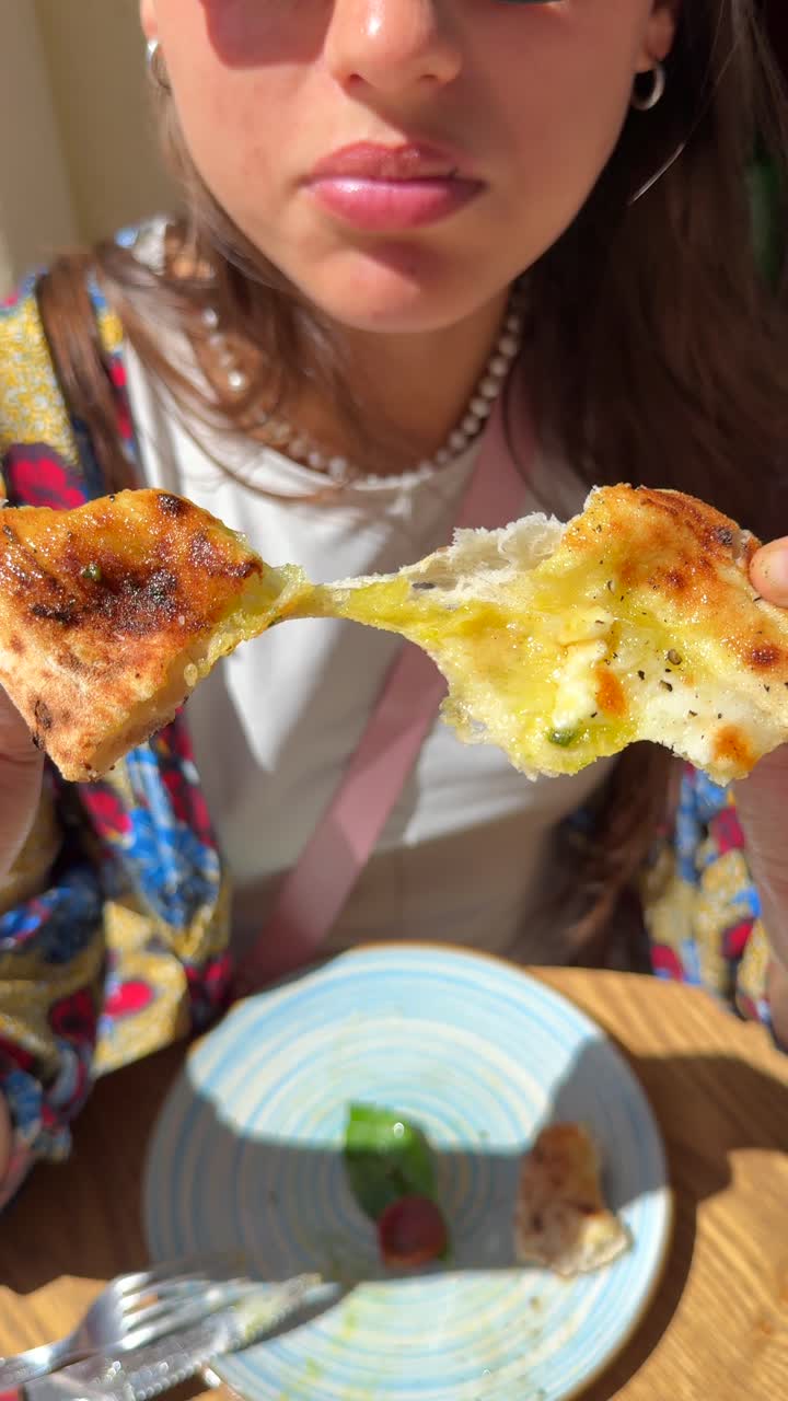 Girl eating a piece of pizza