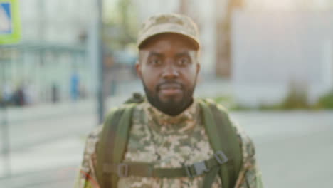 a handsome soldier smiles in the streets