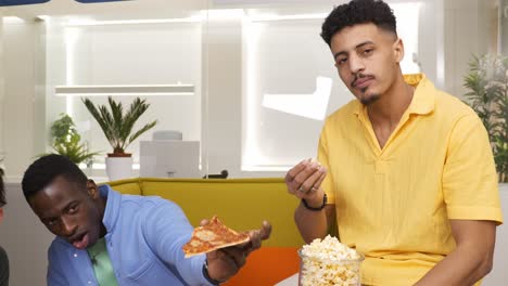 two friends enjoying snacks and entertainment at home