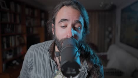 man singing into a microphone at home
