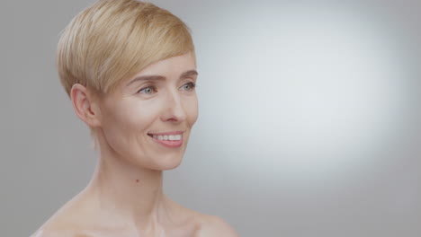 portrait of a smiling woman with short blonde hair