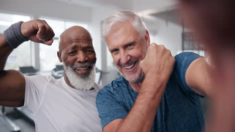 two senior men flexing in the gym