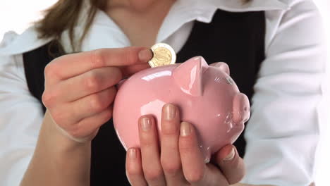 woman saving money in a piggy bank