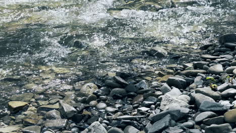 creek on stone landscape. view of flowing river in mountain with sun reflection.