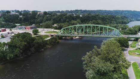 aerial view of easton pa and delaware river approaching large industrial bridge with woods in the background