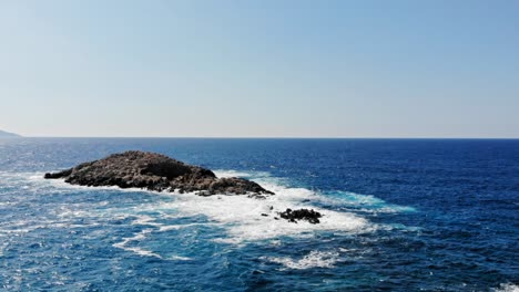 Seascape-With-Foamy-Waves-Splashing-On-Rocks-At-Jerusalem-Beach-In-Greece---aerial-drone-shot