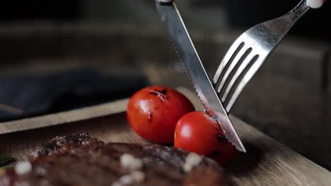 woman eating a steak with tomatoes