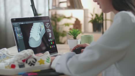 woman designing sneakers on a laptop