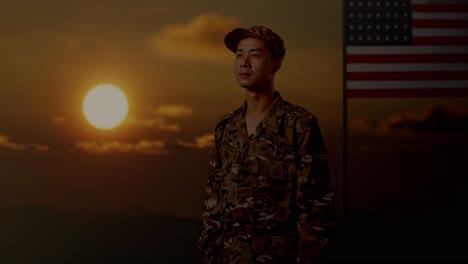 side view of asian man soldier looking around while standing with flag of the united states, sunset time