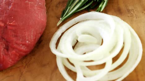 Raw-meat-and-ingredients-on-wooden-board