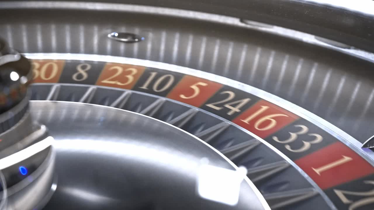 Closeup capturing spinning roulette wheel with ball bouncing erratically before landing randomly on numbered pocket, revealing suspenseful moment of chance and uncertainty