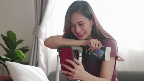 Woman-happy-selfie-portrait-with-her-passport-and-credit-card-before-travel-trip