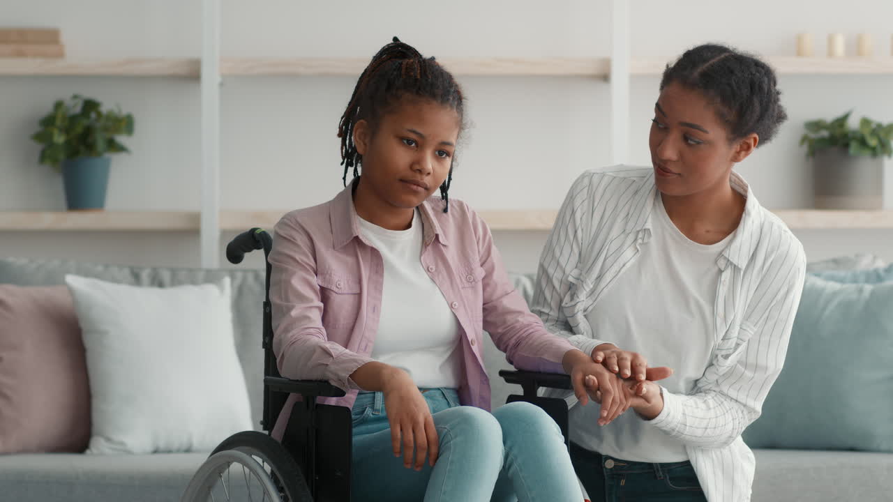Teenager in Wheelchair Receiving Support from a Friend
