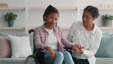 teenager in wheelchair receiving support from a friend