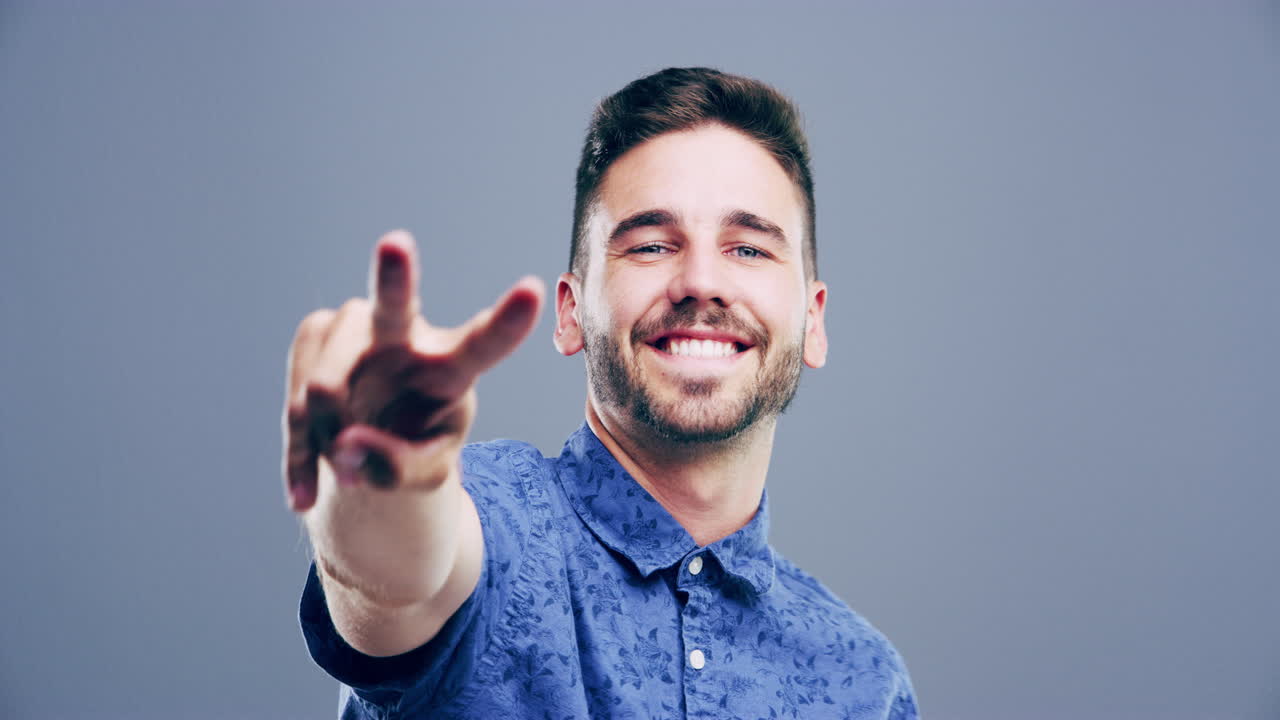 hombre sonriente haciendo un signo de paz