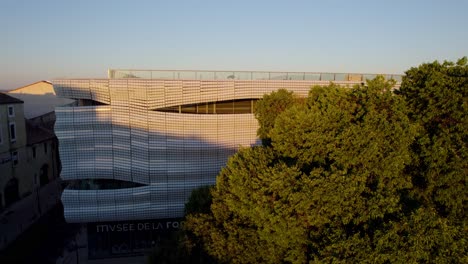 Captivating Architectural Beauty: Sunrise Over Metallic Waves of Modern Building