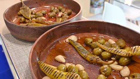 grilled green olive pickles are displayed during the gulf food exhibition, united arab emirates