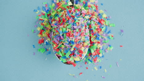 colorful recycled plastic pieces in a spoon