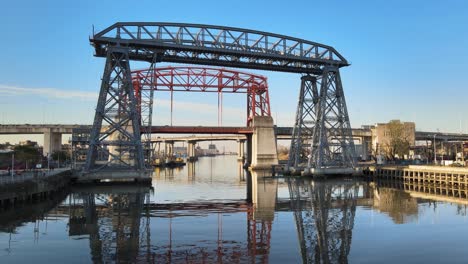 low aerial push-in of puente transbordador and red bridge behind it