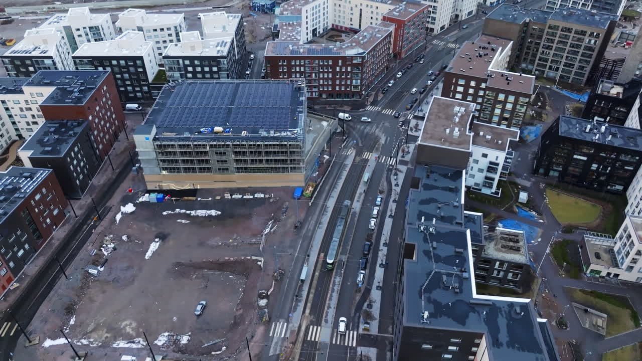 Aerial view following a tram on the streets of Helsinki, cloudy day in Finland
