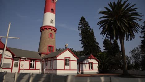 a side angle of the historical swakopmund lighthouse against a blue sky