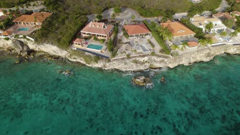 aerial trucking shot of the vacation villas on shore in the caribbean