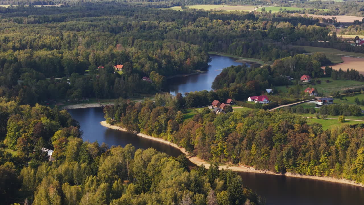 Lush Trees By The Rivershore Village In Koknese, Aizkraukle Municipality, Vidzeme Region Of Latvia. Aerial Drone Shot