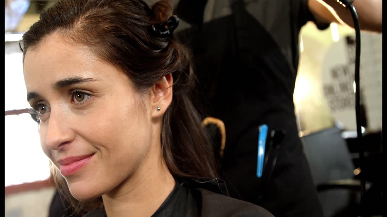 Woman getting her hair dried with hair dryer