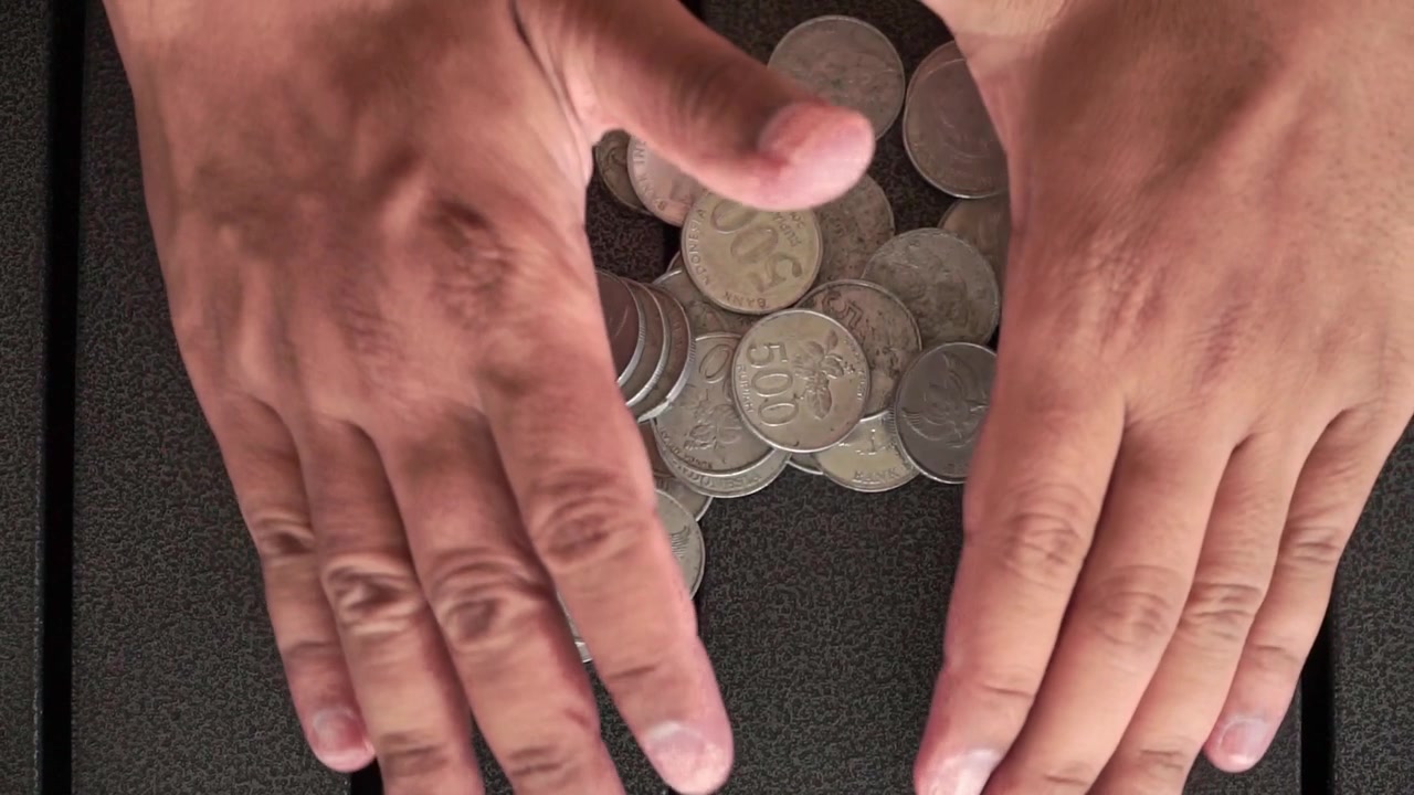 Mani che afferrano monete sul tavolo, concetto di risparmio e finanziario che mostra la gestione del denaro, il budgeting e la raccolta di contanti nella vita quotidiana
