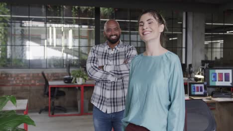 Two-happy-diverse-creative-designers-in-discussion-in-casual-office,-slow-motion