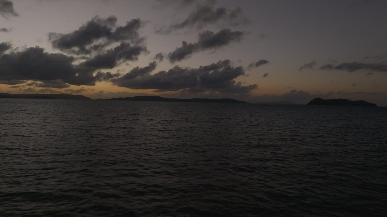 Drone early morning low light pre sunrise flight over the ocean in the Whitsunday Islands, QLD, Australia