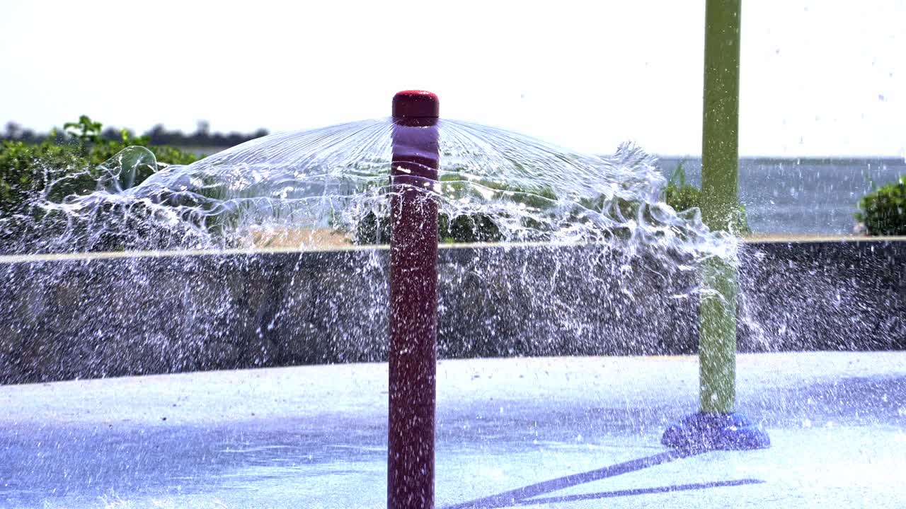 Water sprays up from vibrant structures, creating joyful moments amidst laughter and play